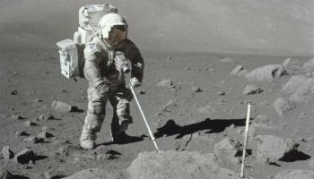 Astronaut on the moon, having his spacesuit covered by dust.
